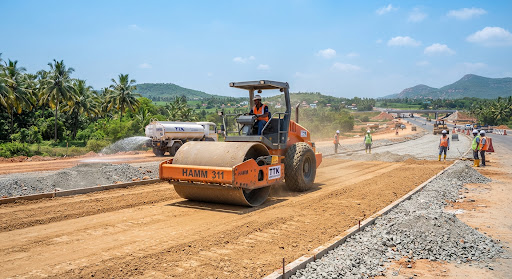 Single-drum soil compactor consolidating a subbase layer