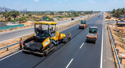 Sensor paver laying dense bituminous macadam on a four-lane expressway