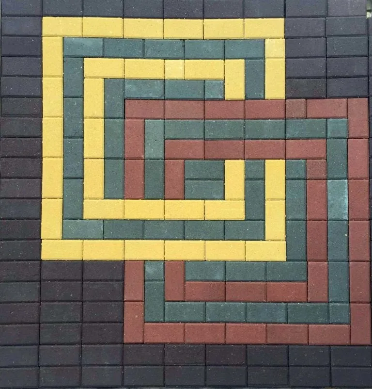 Rectangle pavers in three colours, laid as a pattern.